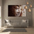 Living room with a large Buddha artwork on the wall, gray sofa, and pendant lights.
