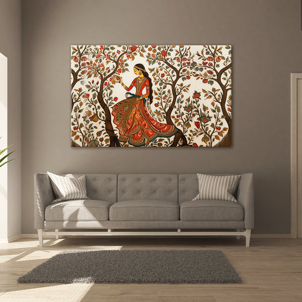 Decorative wall art of a woman in an ornate dress in a tree above a gray sofa.