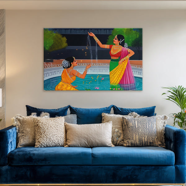 Blue sofa with decorative pillows and a colorful painting of two women on the wall.
