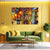 Living room with a green sofa, coffee table, and colorful painting on a yellow wall.