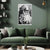 Living room with a green sofa, decorative pillows, and a wall poster of an elderly man with text.