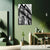 Living room with green walls, a black and white architectural print, and decorative vases.