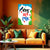 Orange sofa with green and yellow cushions in a room with a colorful wall poster.