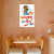 Cartoon character poster on a wall with a small table and chairs below.