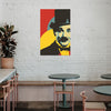 Colorful portrait of a famous figure on a white brick wall above a cafe setting.