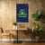Poster with space-themed text on a wall above a table with chairs and plants.
